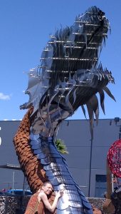 Bree hugging a dragon made of metal