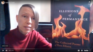 Briana holding the brilliantly dark book "Illusions of Permanence," from which she's about to read the poem "Cupid" in the YouTube video this image links to.